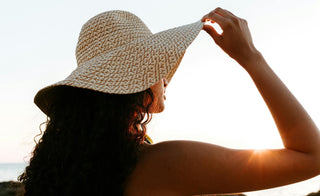 Woman tilting sunhat up