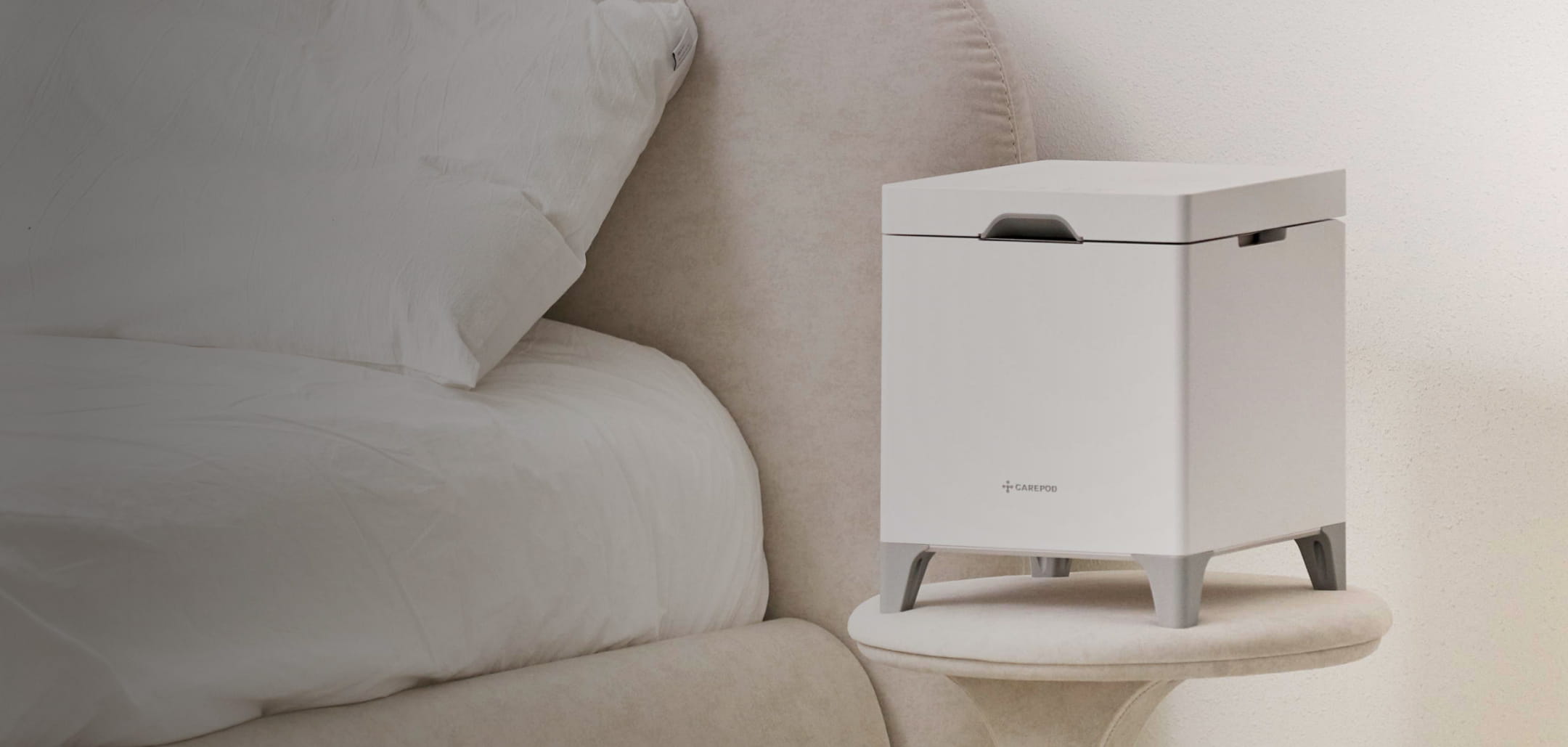 Carepod humidifier on a bedside table next to a bed