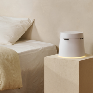 Carepod humidifier on a bedside pedestal next to a bed